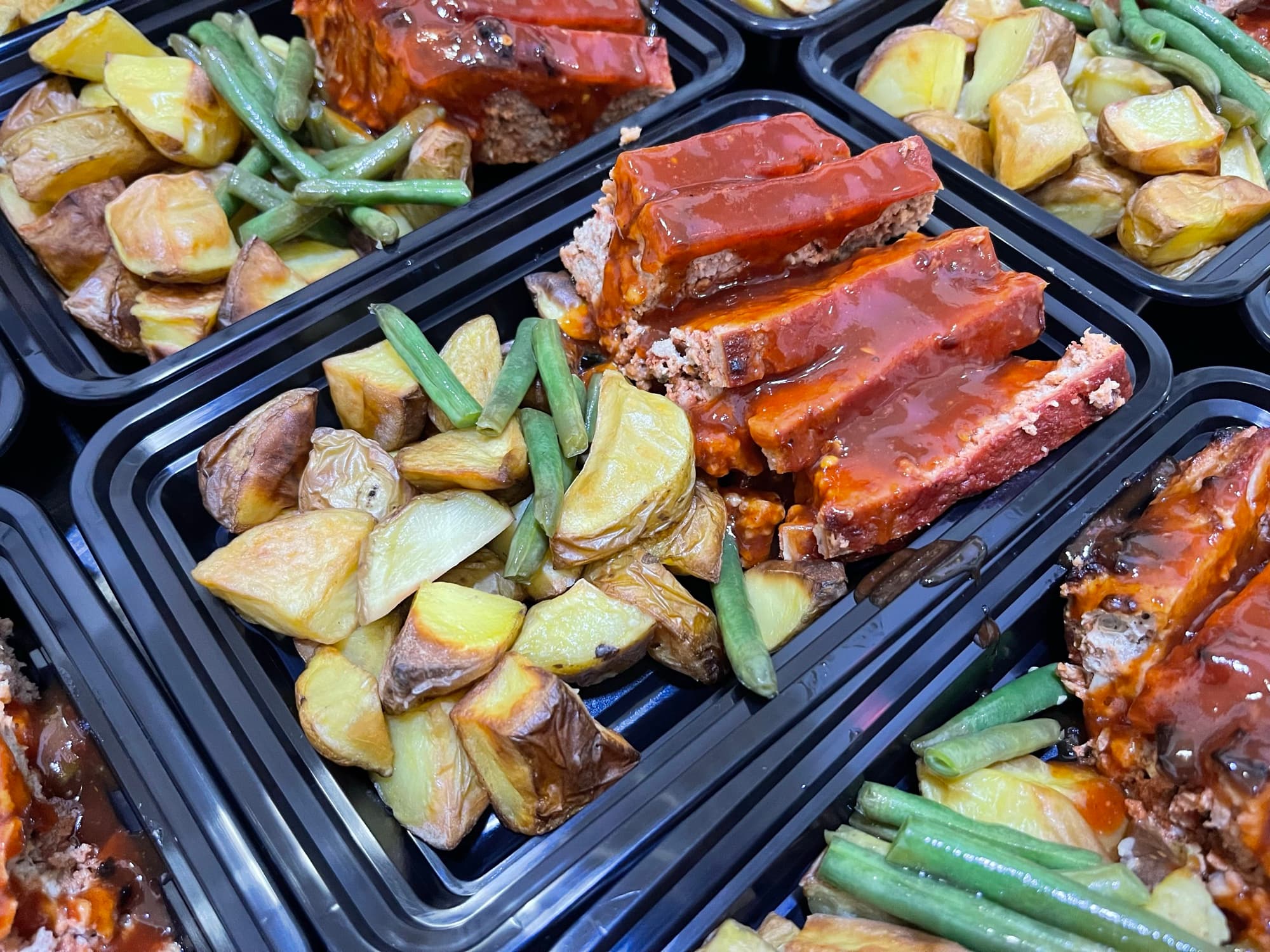 Prepared meatloaf meals with roasted potatoes and green beans at Nutrition Elite