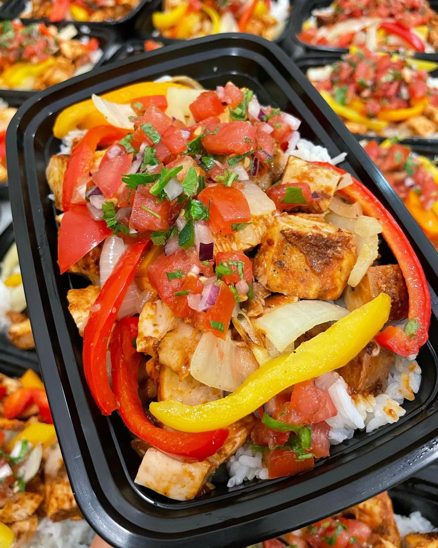 NE TIME Meals adobo chicken rice bowl with peppers, onions, and diced tomatoes